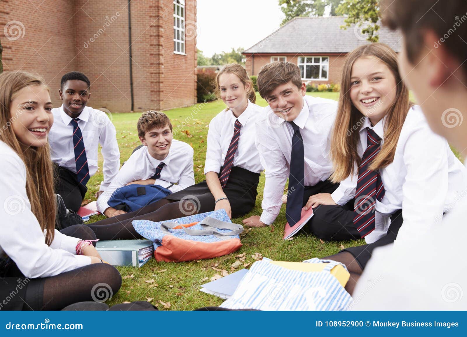 teenage students in uniform working on project outdoors