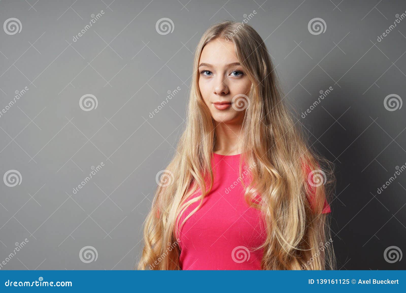 teenage woman with long blond hair and contented smile