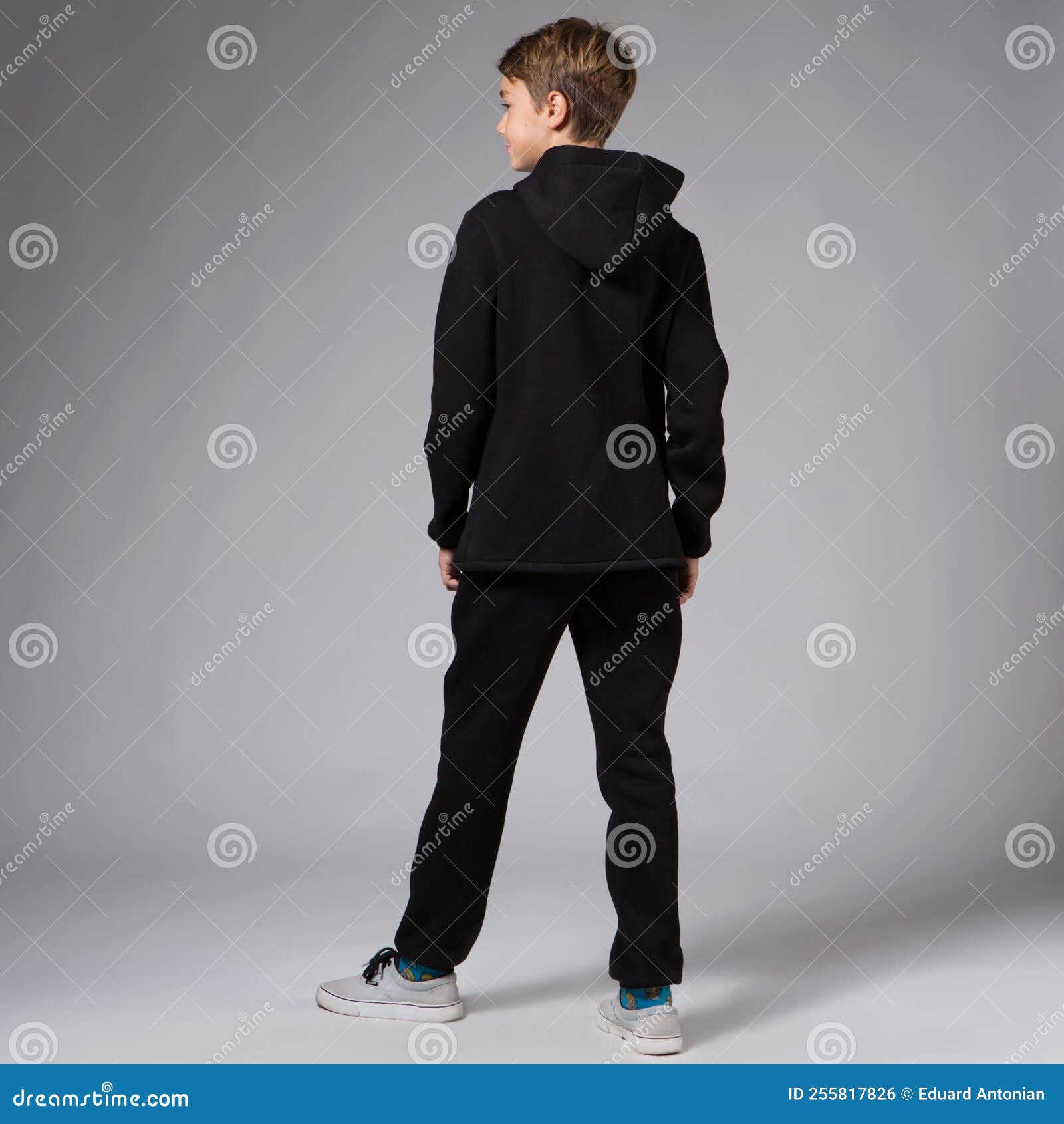 A Teenager Boy in a Black Tracksuit, in Full Growth, Turned His Back ...