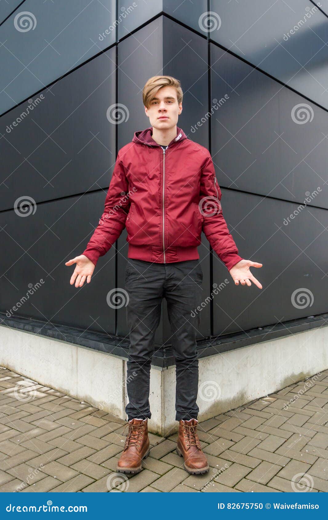 teenager boy gesticulating doubt and question over urban background