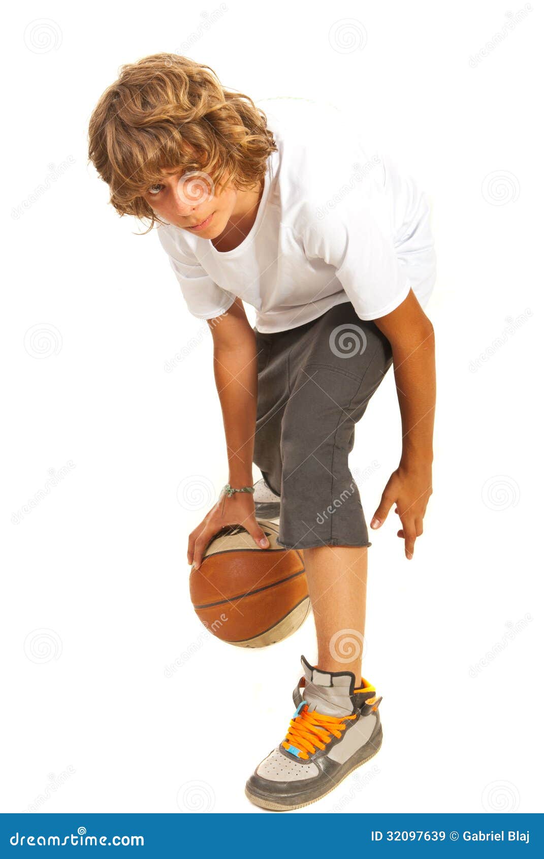 teenager dribbling basketball