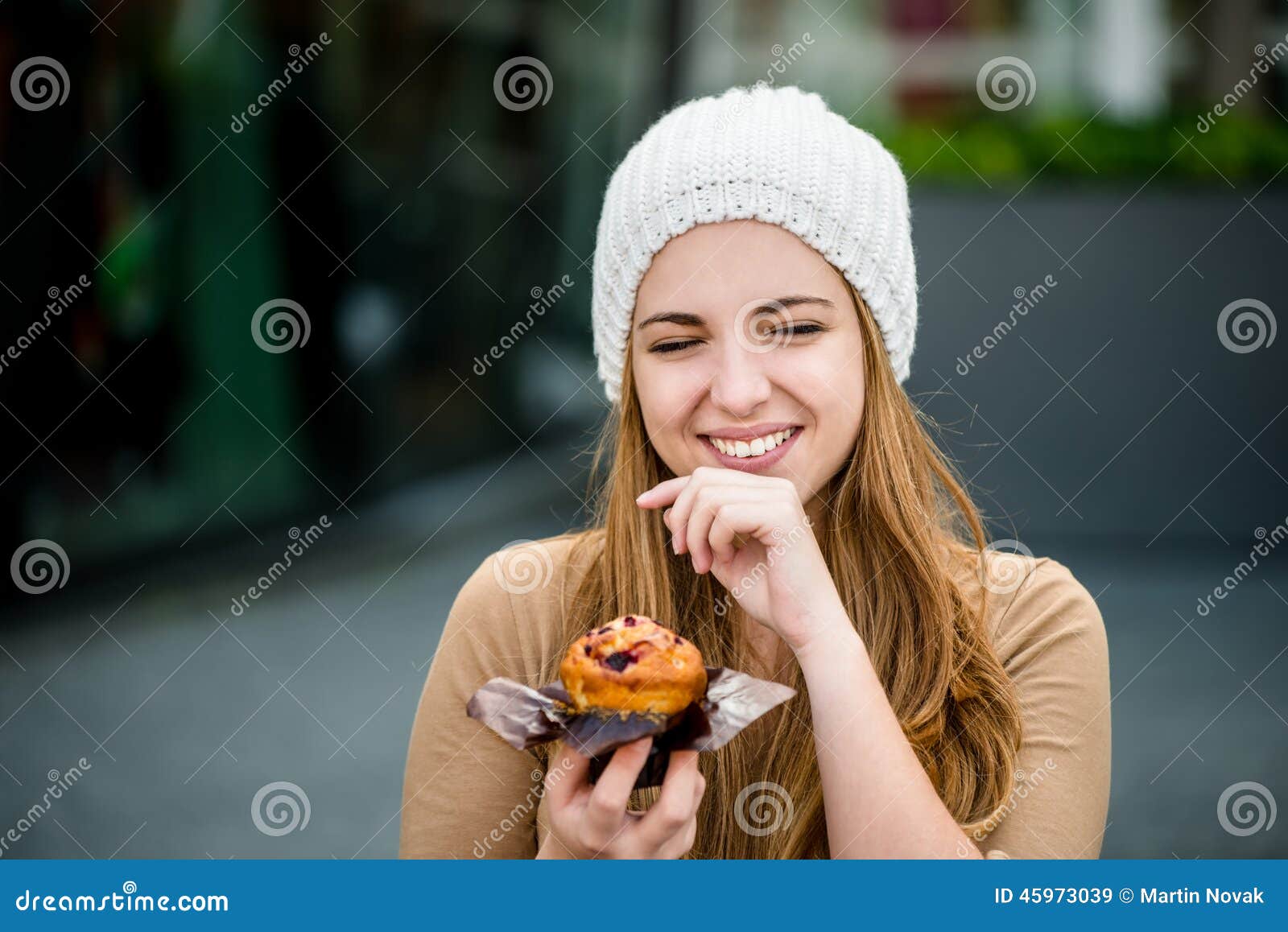 Authentic smiling young beautiful girl in fashionable clothes