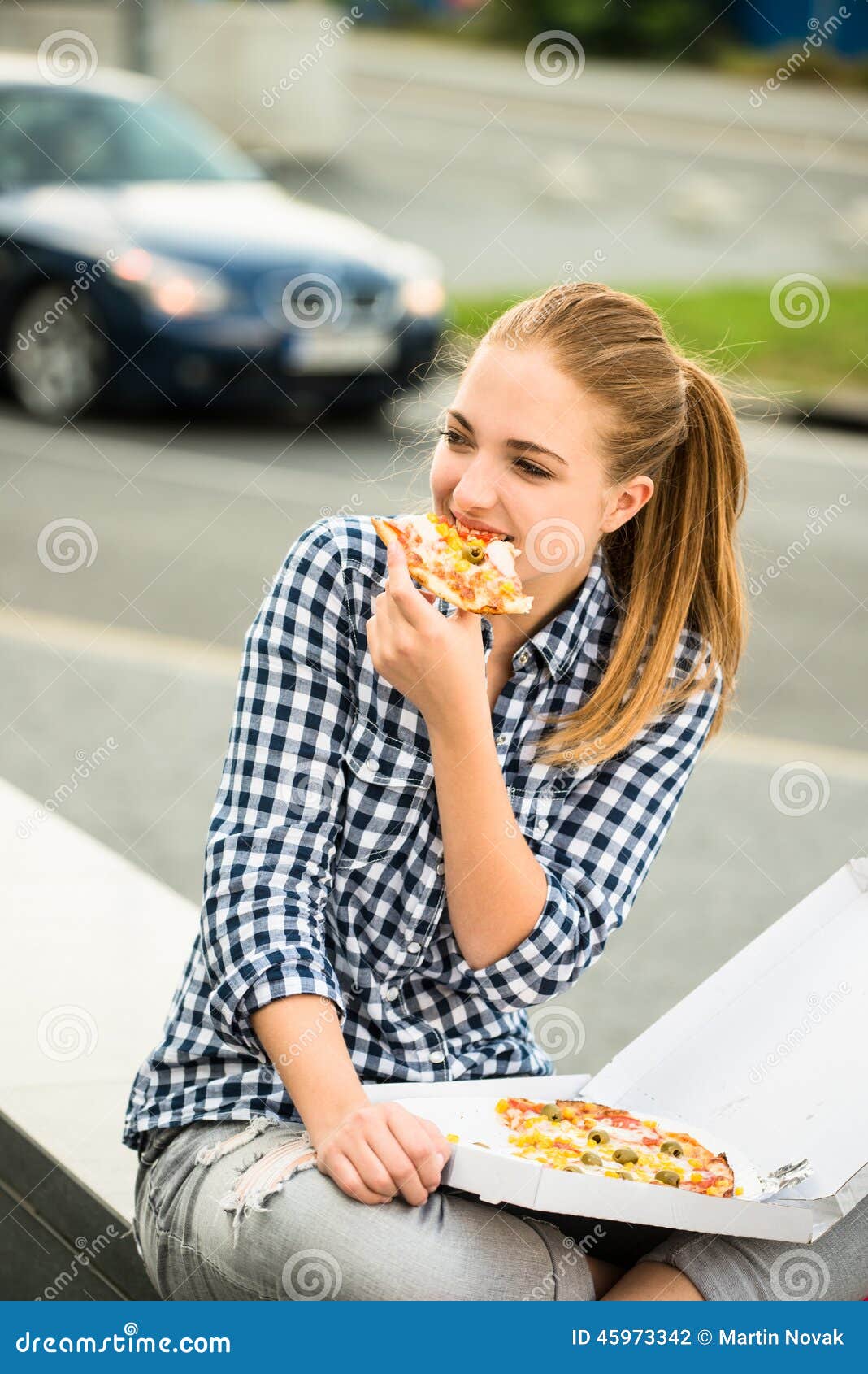 Teenager Eating Pizza In Street Sto