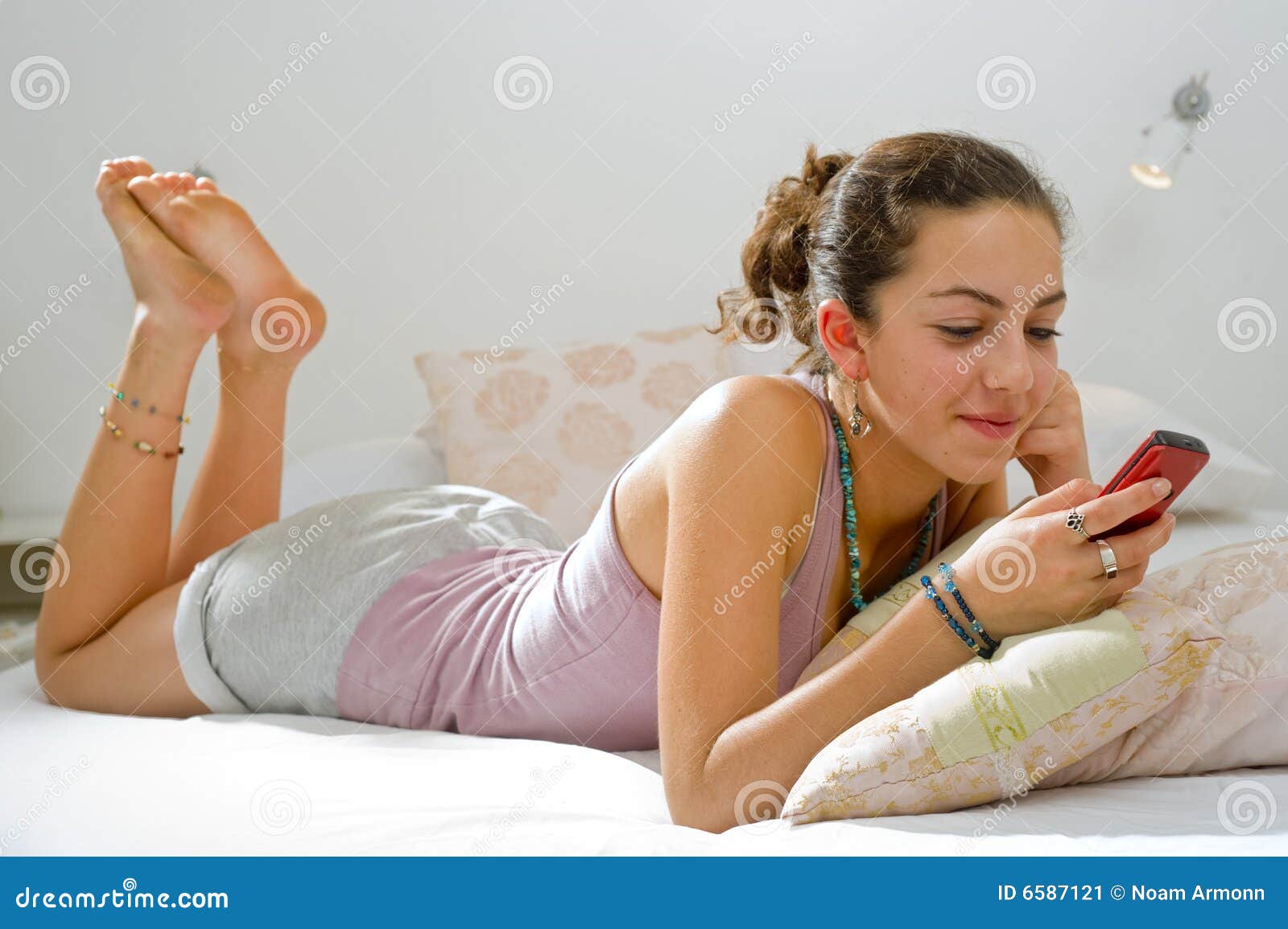 teenager girl bed cell phone