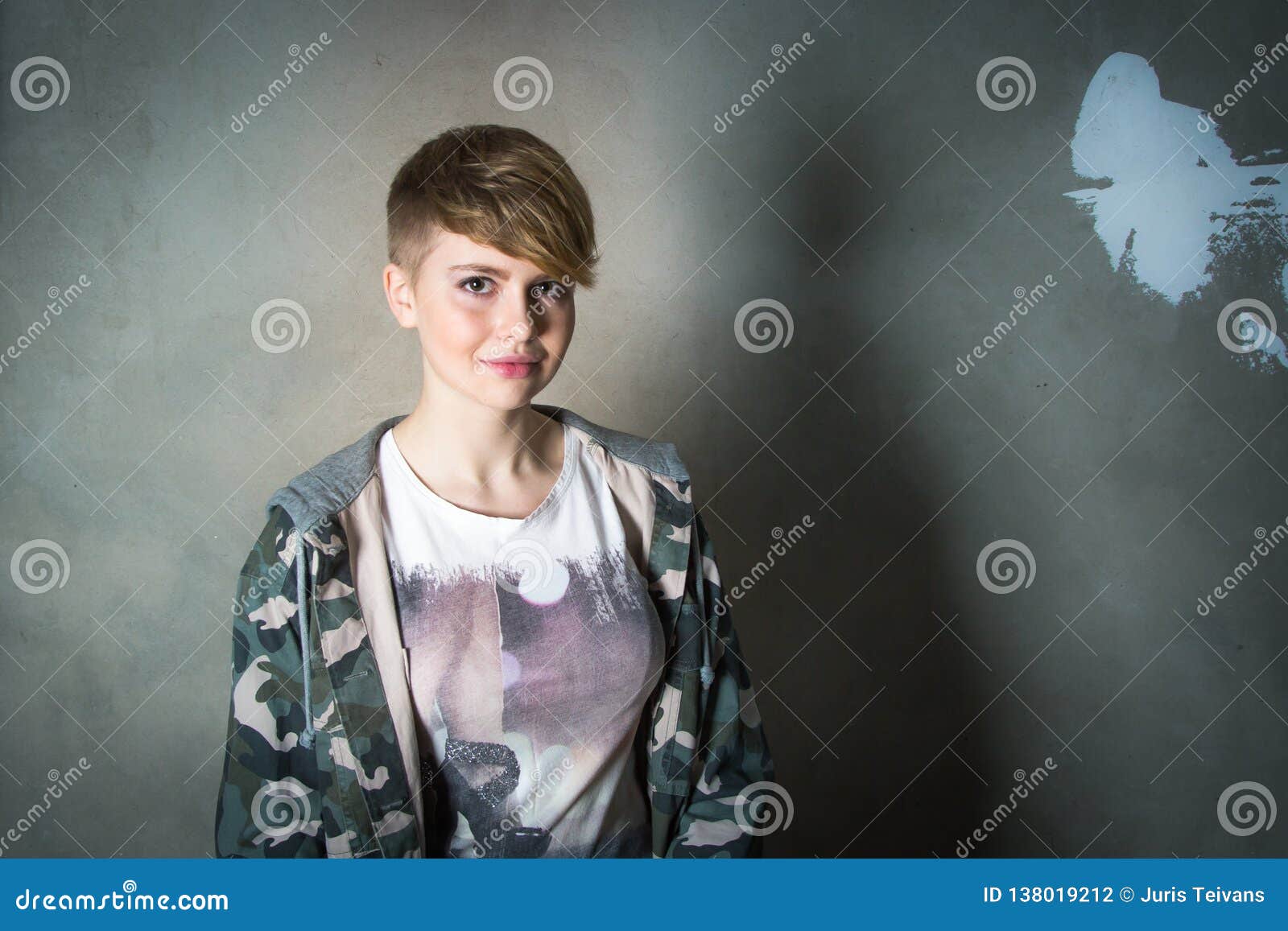 Young Girl With Short Haircut Concrete Wall On Background