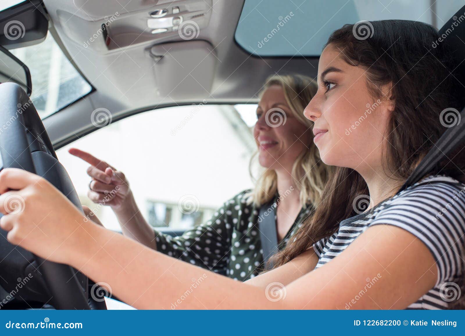 teenager having driving lesson with female instructor