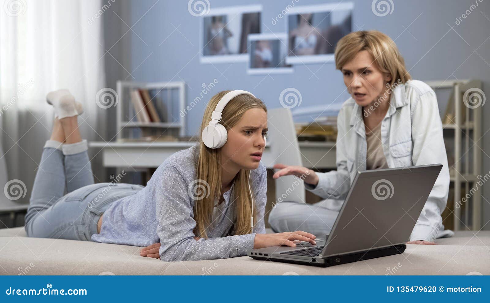 Teenage son listening music in headphones or playing online games ignoring  his mother Stock Photo - Alamy