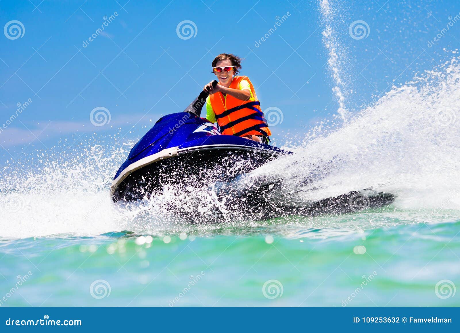 teenager on jet ski. teen age boy water skiing.