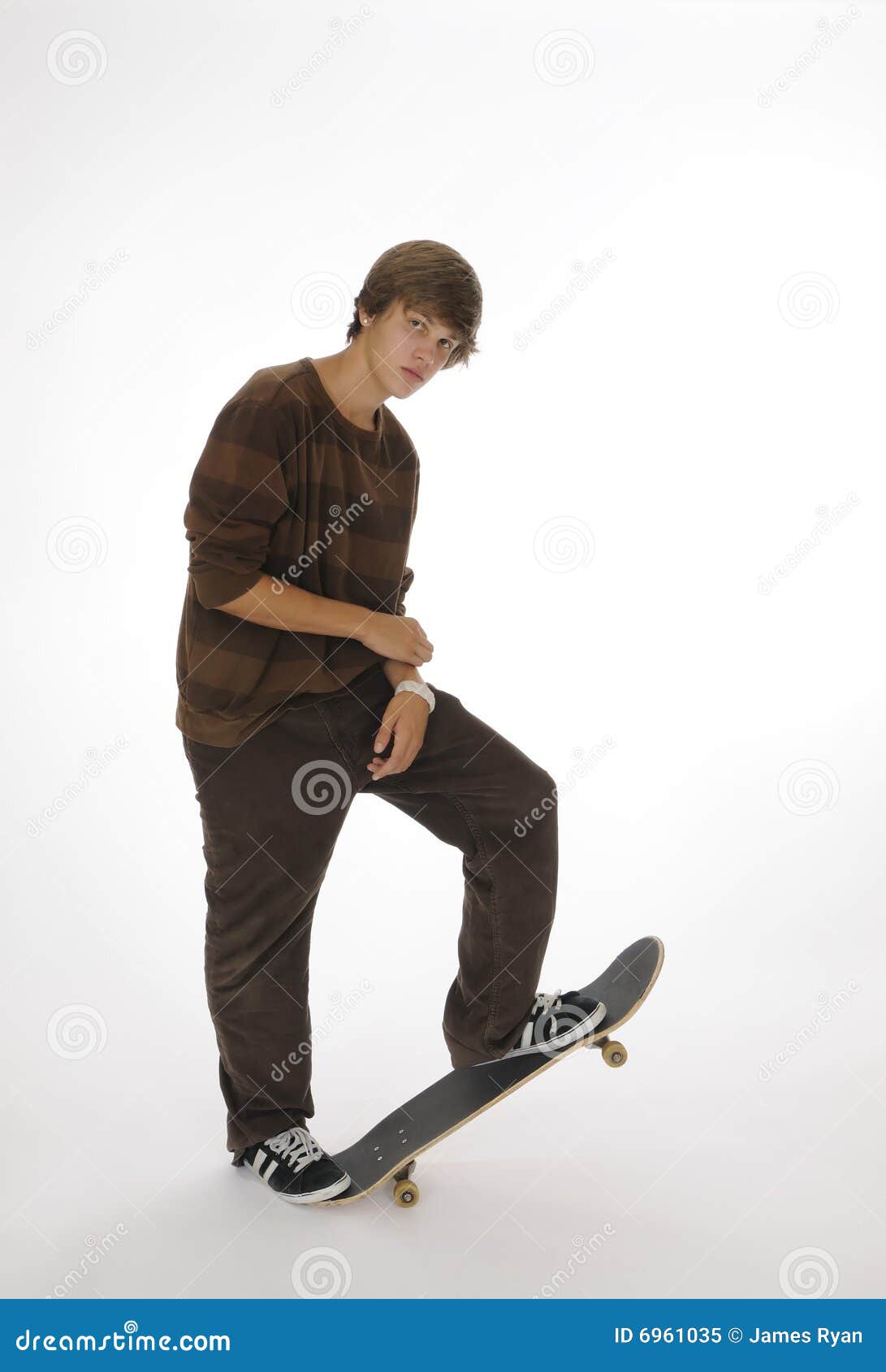 Teenager Leaning while Standing on Skateboard Stock Image Image of