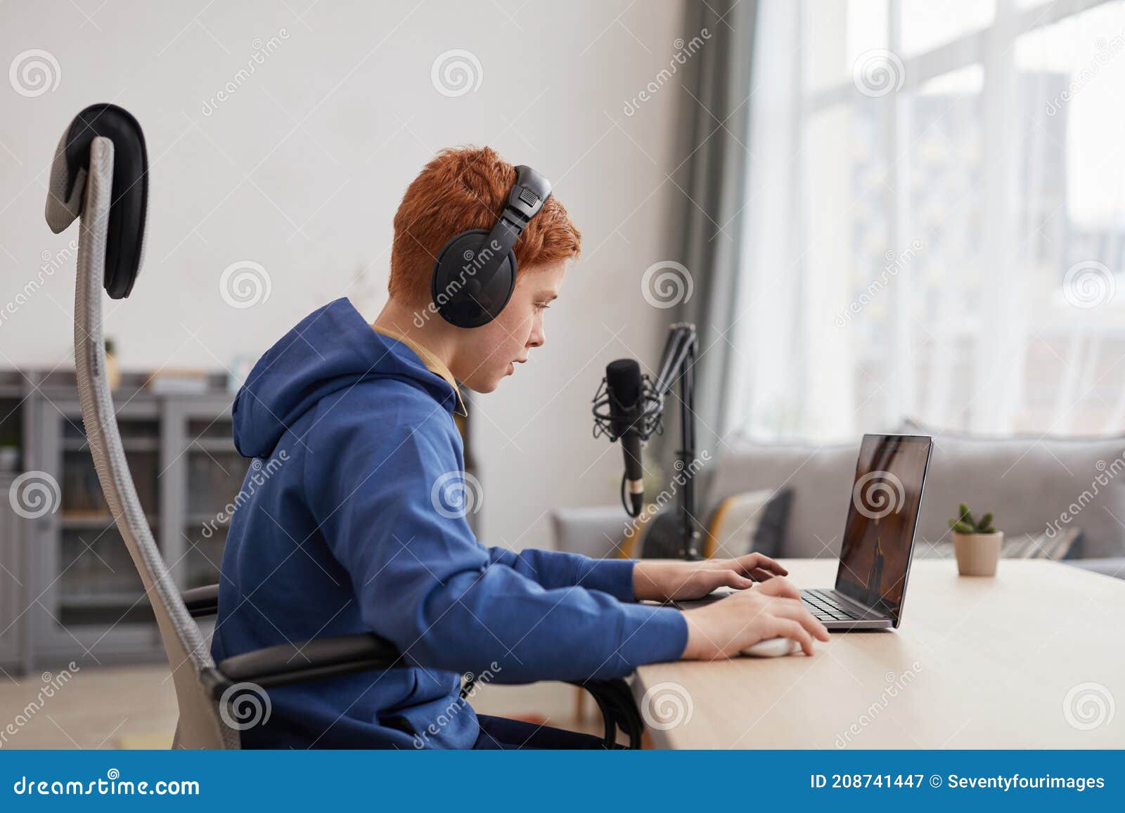 Teenager Boy Online Plays A Computer Game With Headphones And A