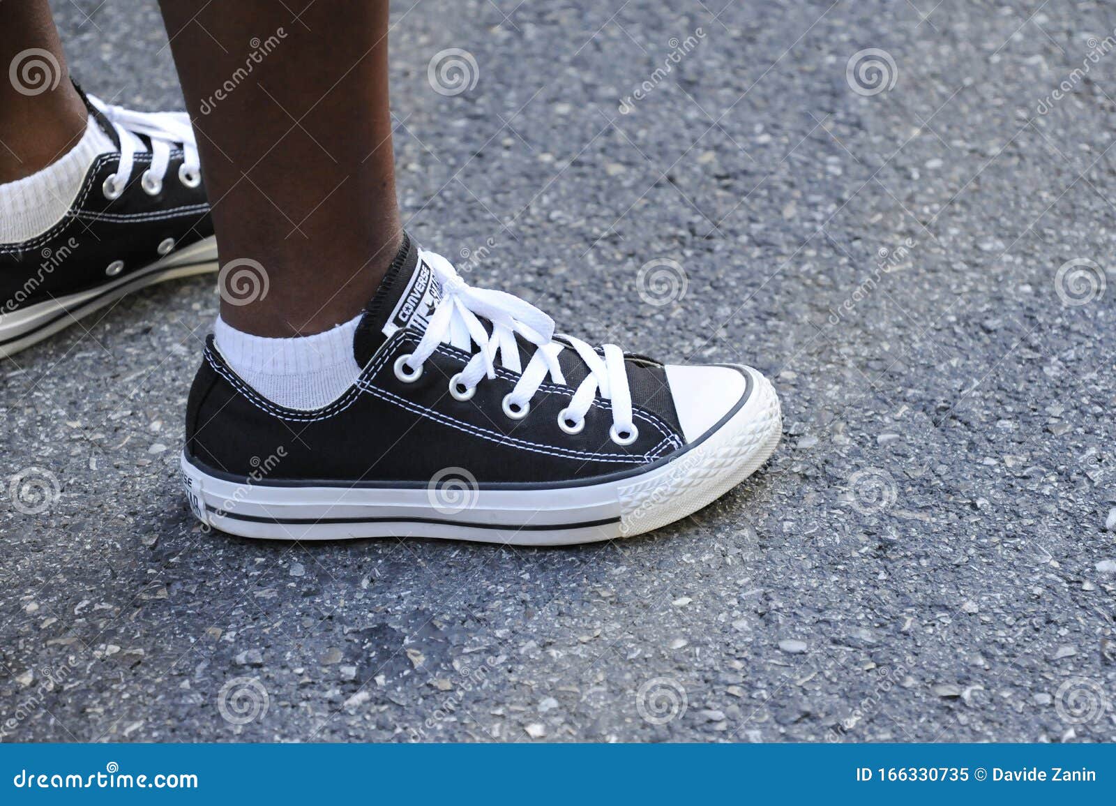 Teenager S Feet in a Pair of Black Canvas All-Stars Casual Shoes Stands on  Urban Asphalt Road Editorial Image - Image of retro, allstars: 166330735