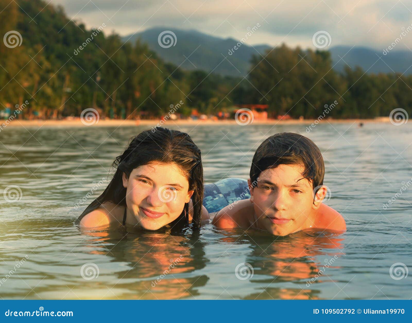 Teenager Siblings Couple Brother and Sister Swimming in the Sea Stock