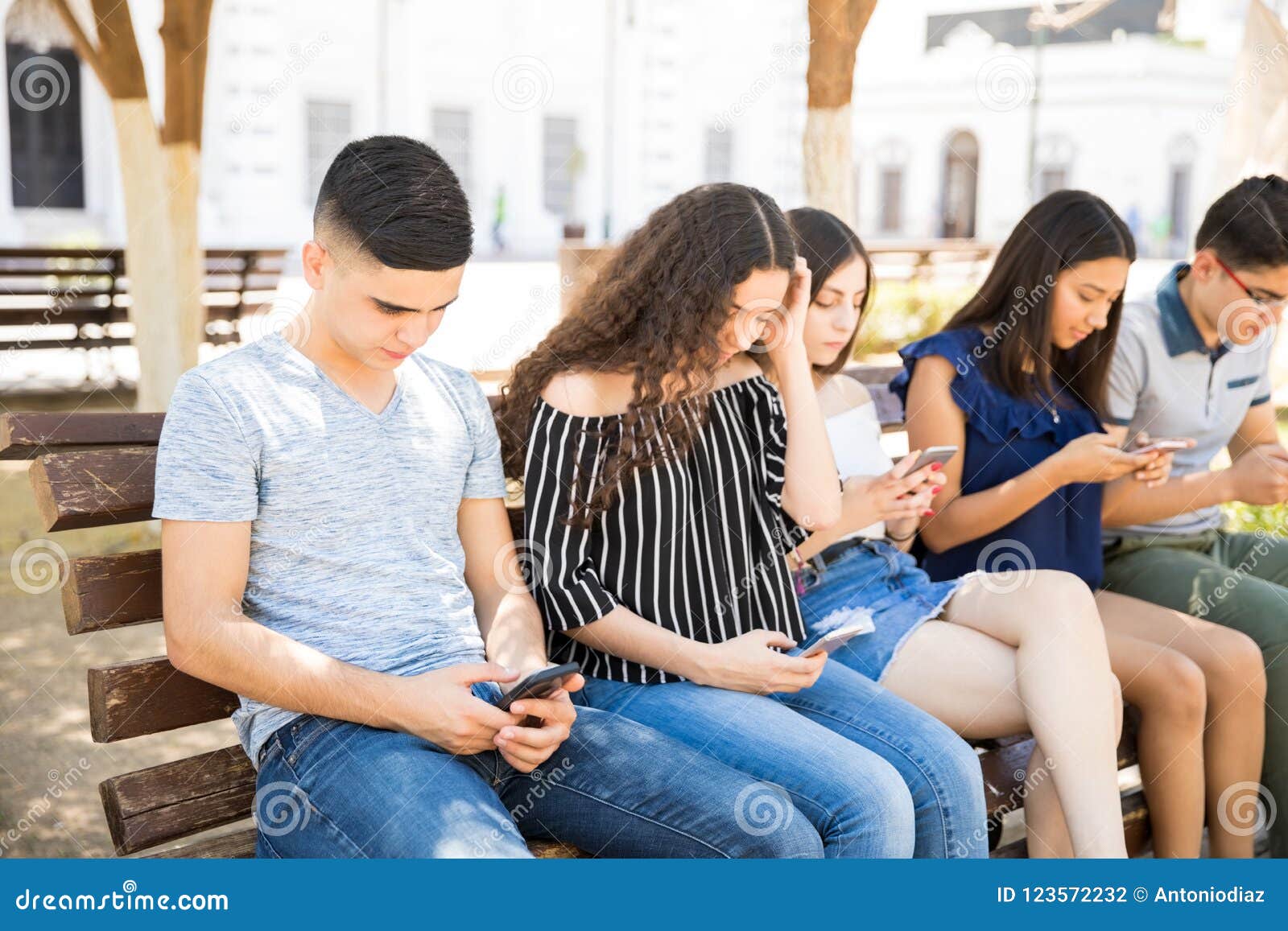 teenager social networking with tech devices