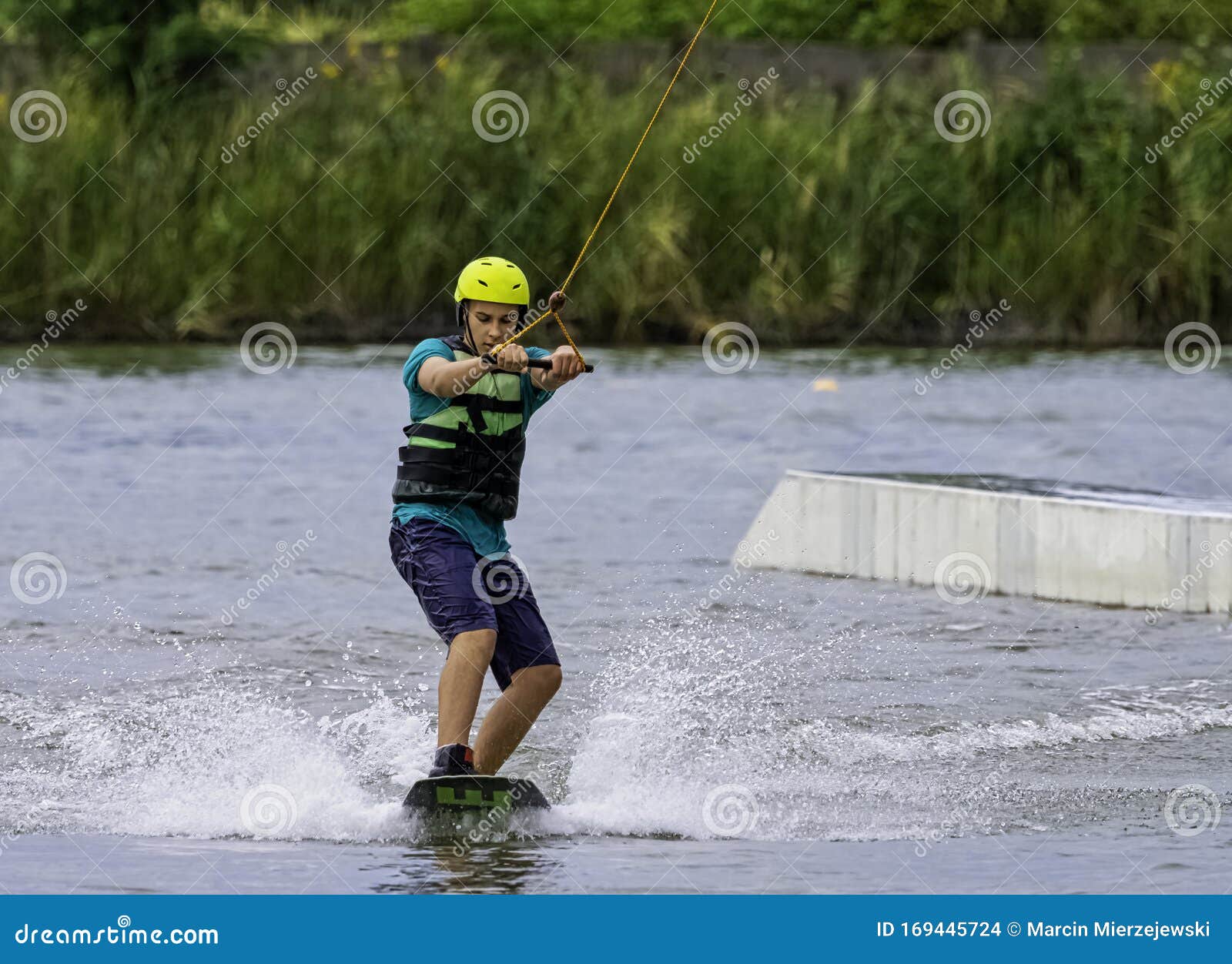 teenager wakeboarding on a lake - brwinow, masovia, poland