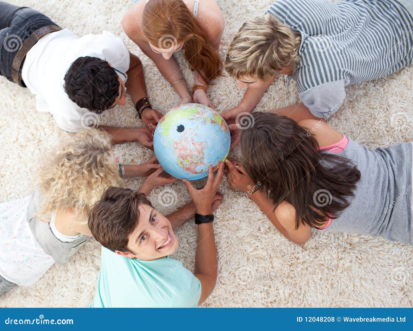 teenagers examining a terrestrial globe