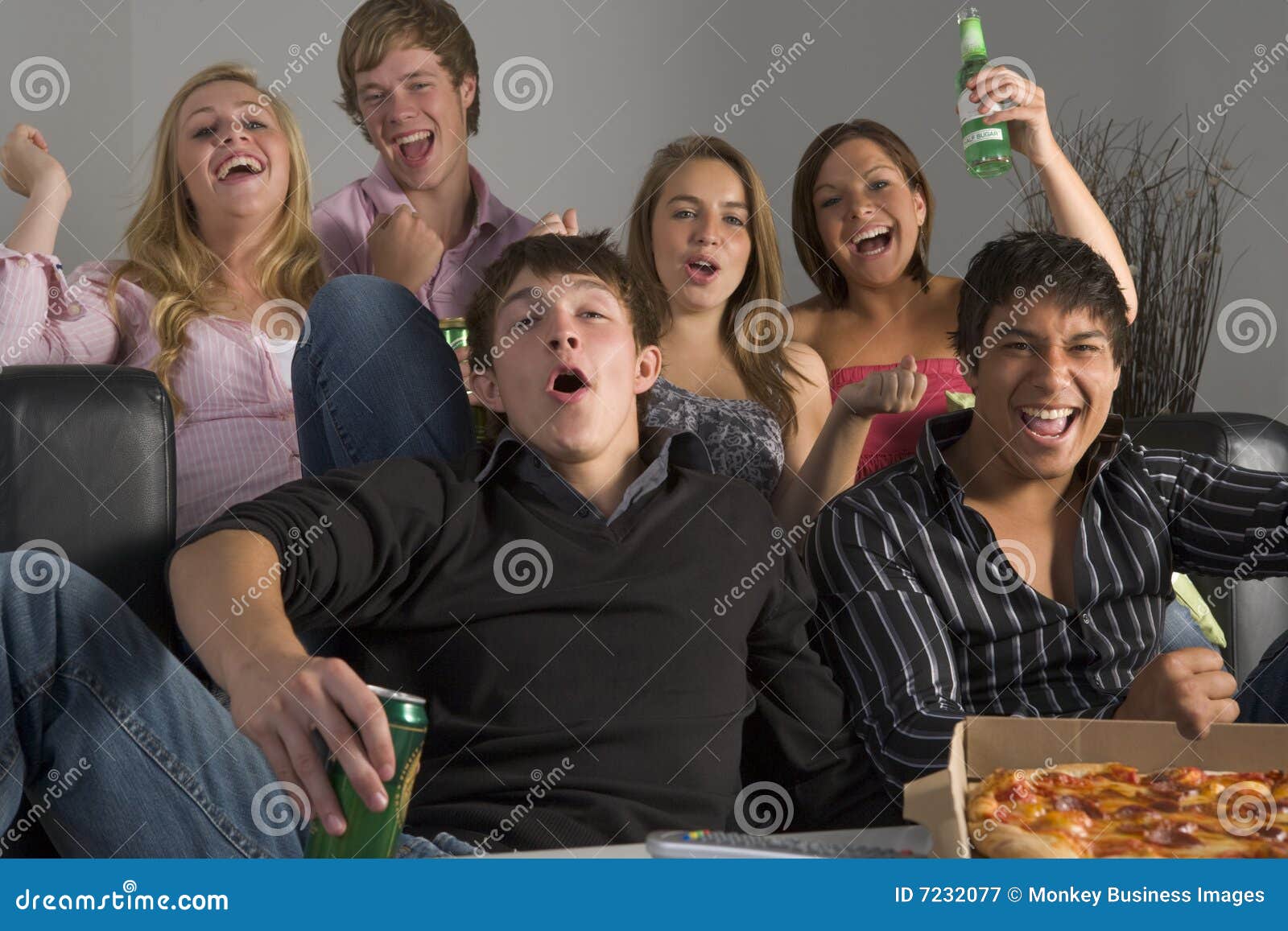 teenagers having fun and eating pizza