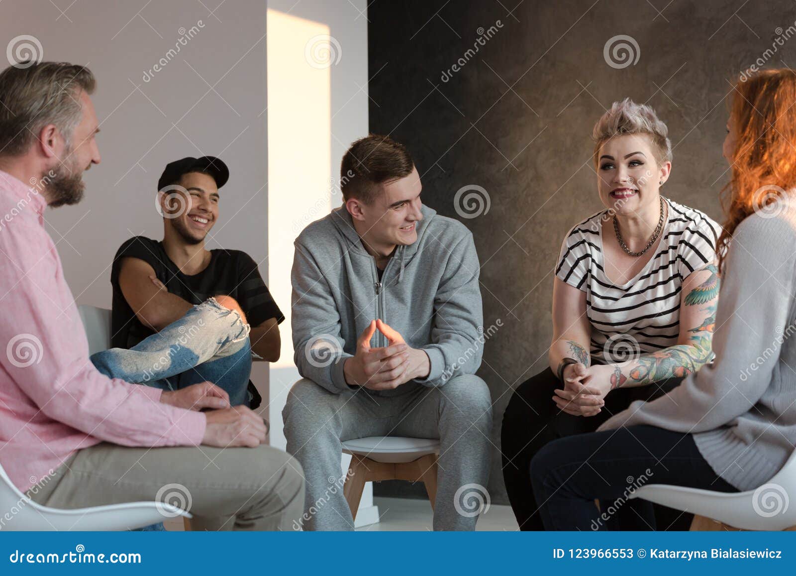 teenagers laughing during a group counseling session for youth