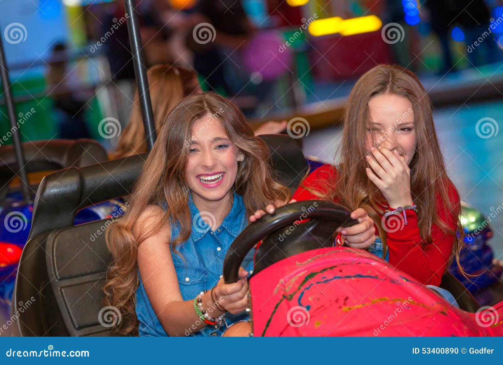 teens at fun fair riding dodgems