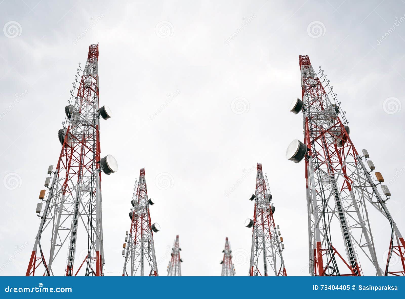telecommunication towers with tv antennas and satellite dish on clear sky, black and white