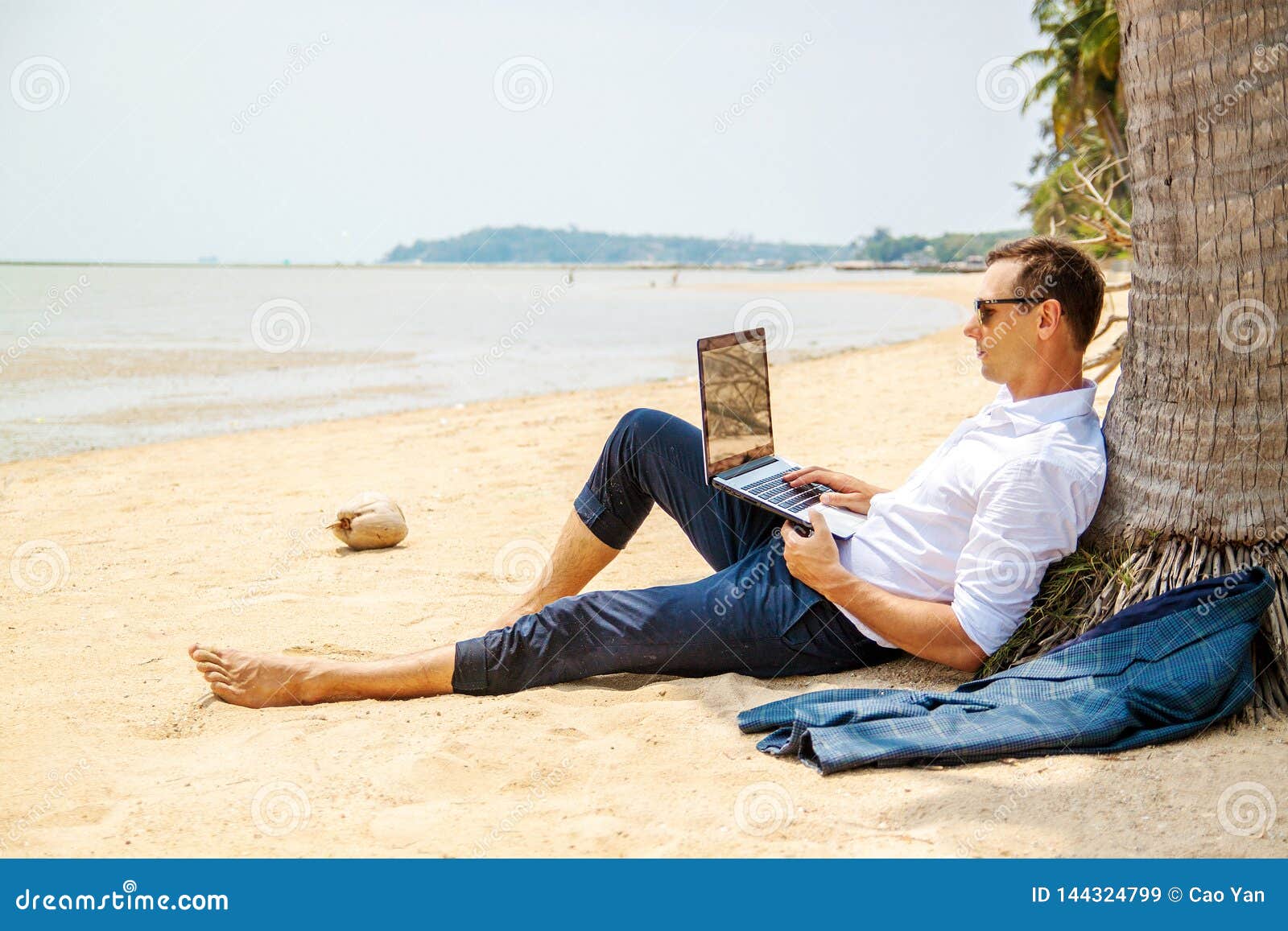 telecommuting, businessman relaxing on the beach with laptop and palm, freelancer workplace, dream job.