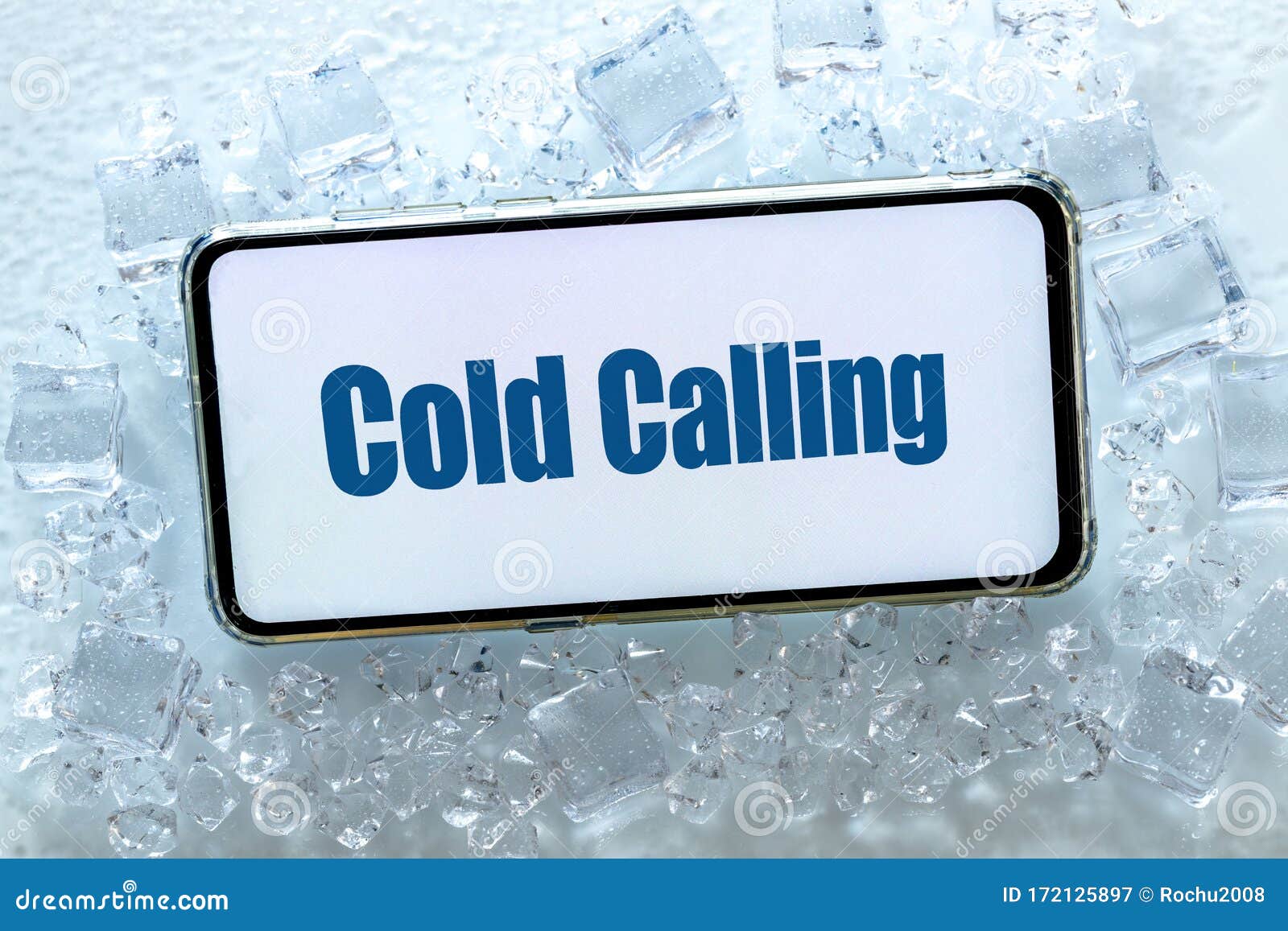 a telephone lying in the ice with the words `cold calling` pharse, business concept of contacting and establishing cooperation