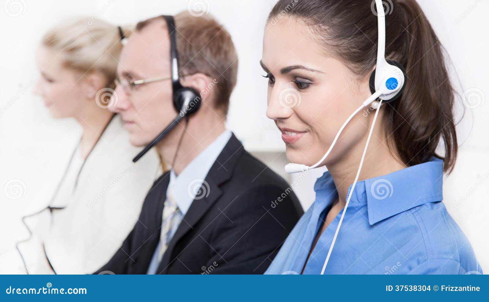 telesales or helpdesk team with headsets - workers at call center.
