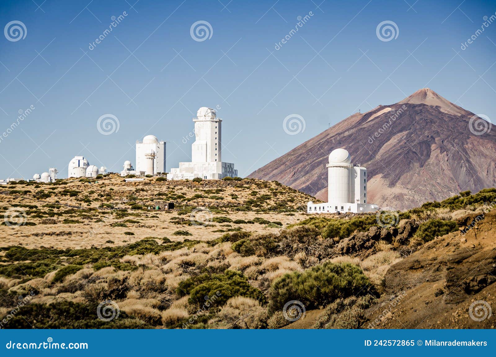 telescopes of tenerife. slooh observatory in las canadas national park. telescope domes with el teide volcano in the background.