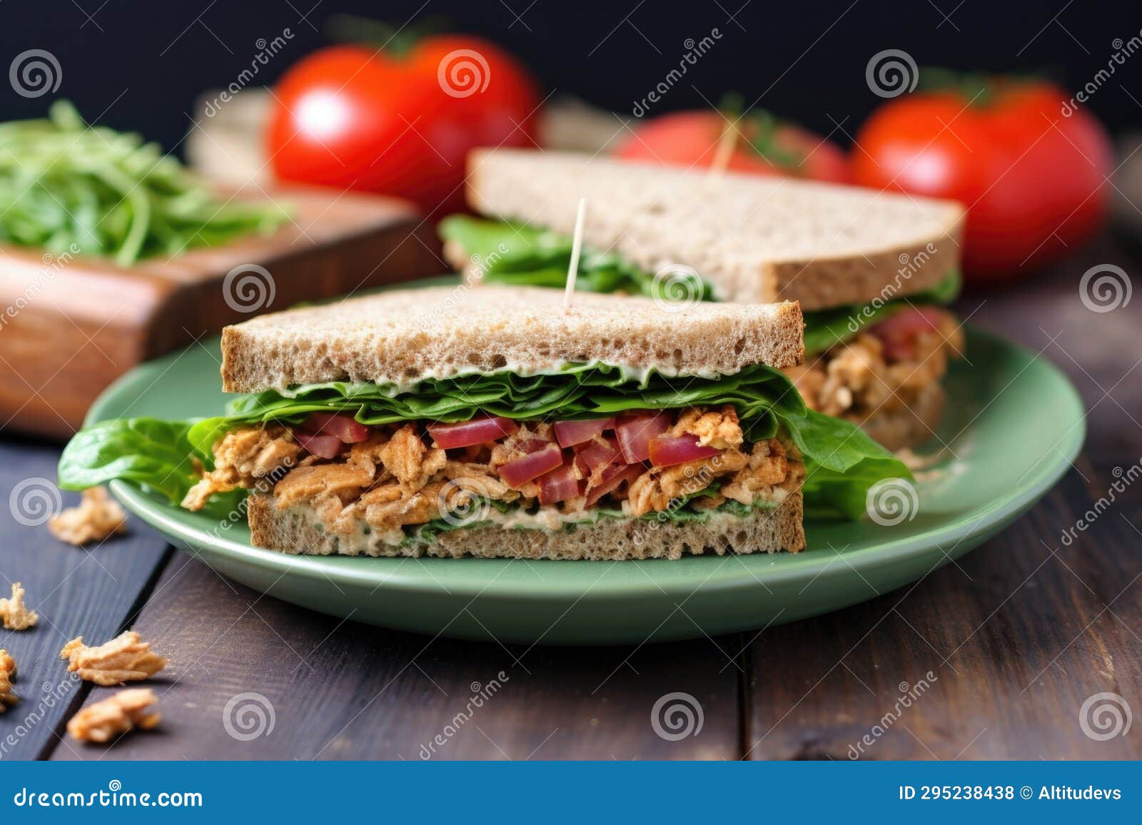 Tempeh Sandwich with Lettuce and Tomato on a Glass Dish Stock Photo