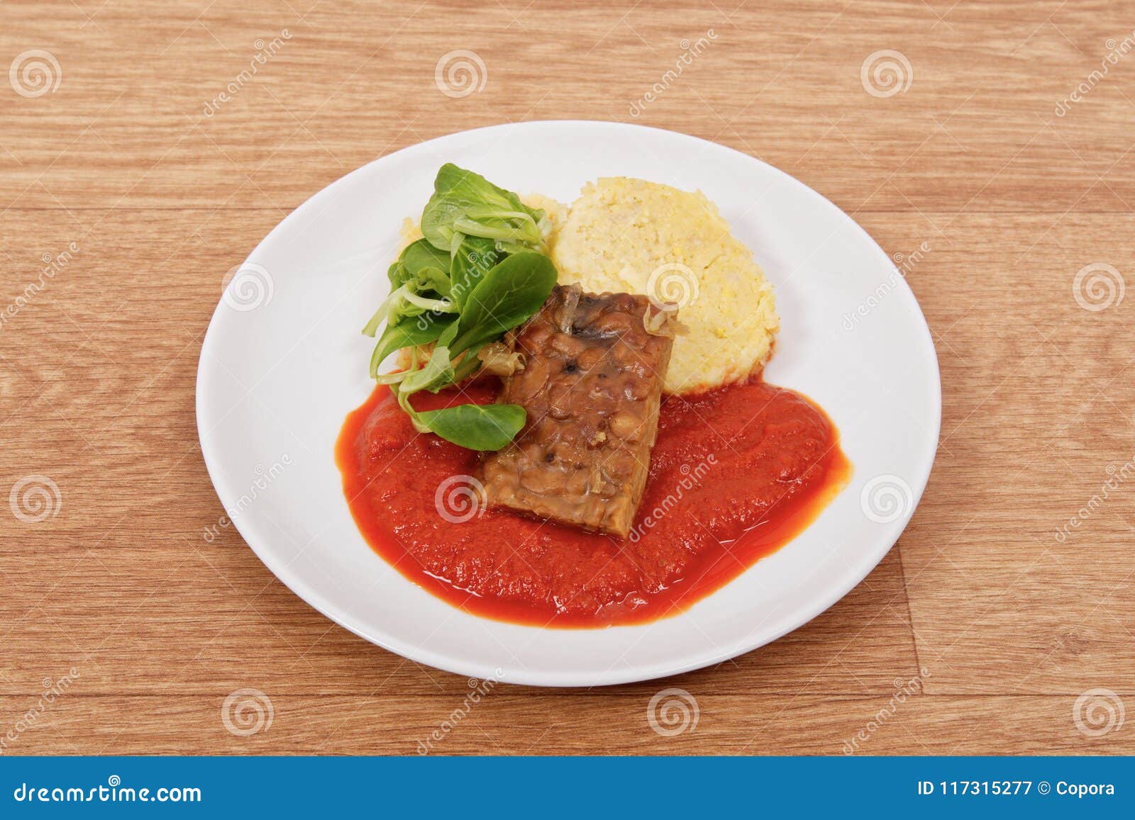 Tempeh with Tomato Sauce and Dumplings on a Table Stock Image Image