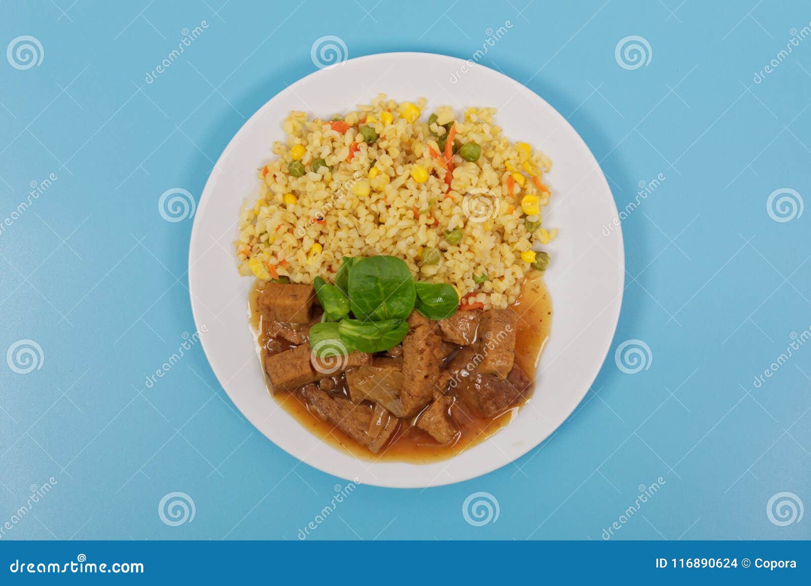 Tempeh with Tomato Sauce and Millets on a Blue Stock Photo Image of