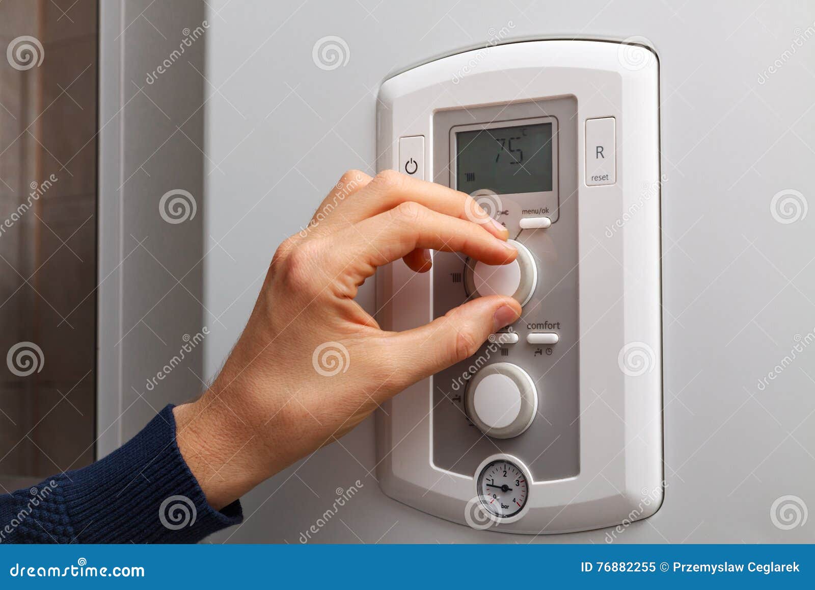 Men Hand Regulate The Temperature Of Hot Water In Gas Water Heater. Stock Photography