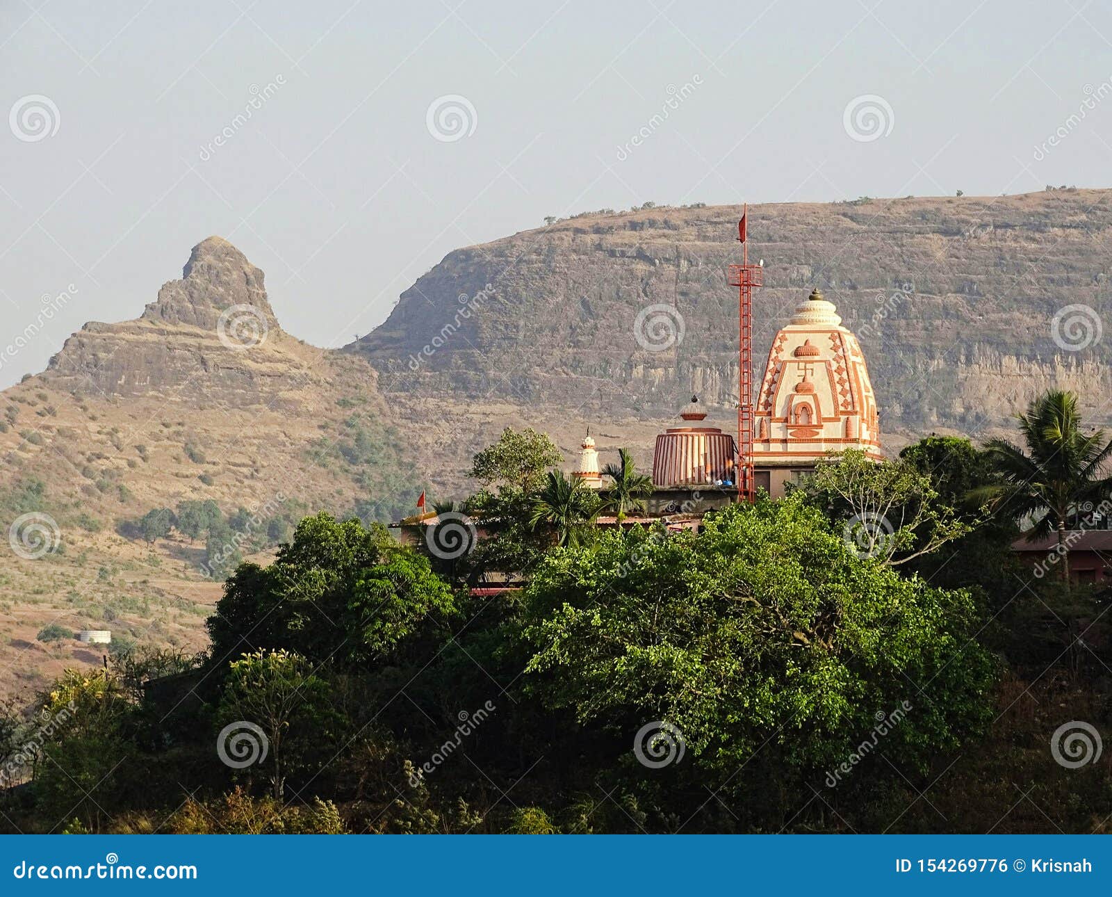 temple on a hill top in nashik, maharashtra with plateaus in background