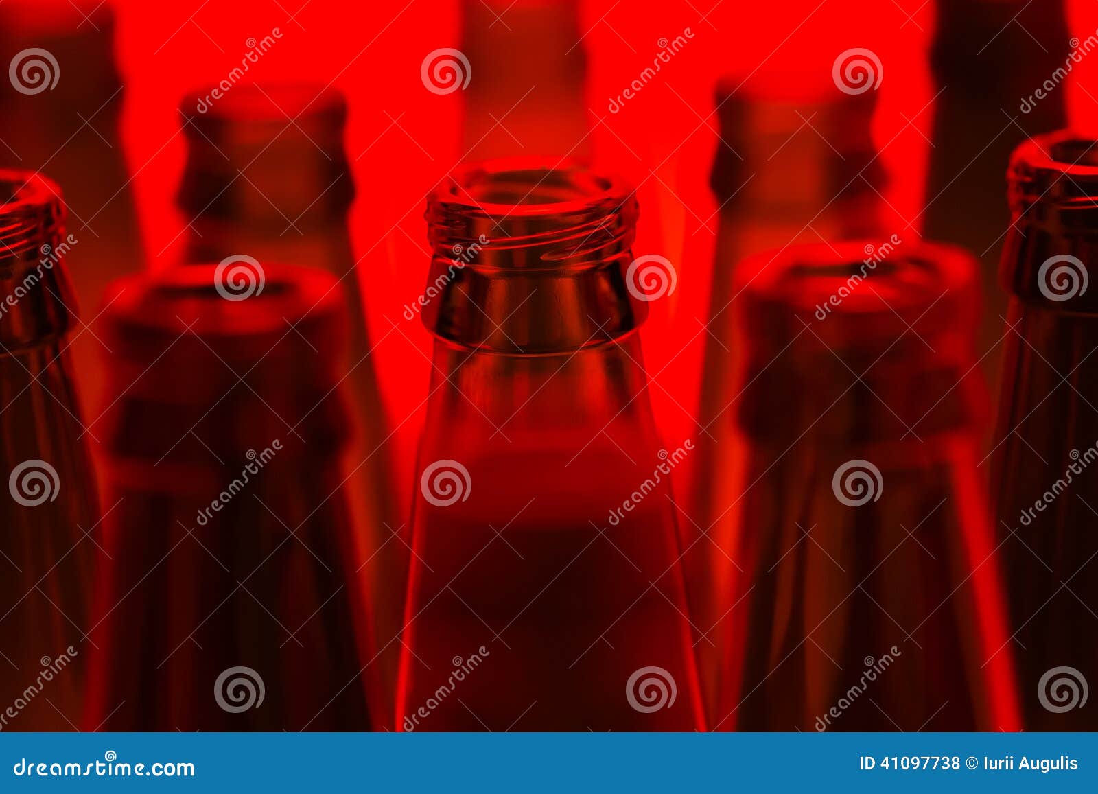 Ten Green Empty Beer Bottles Shot with Red Light. Stock Photo Image
