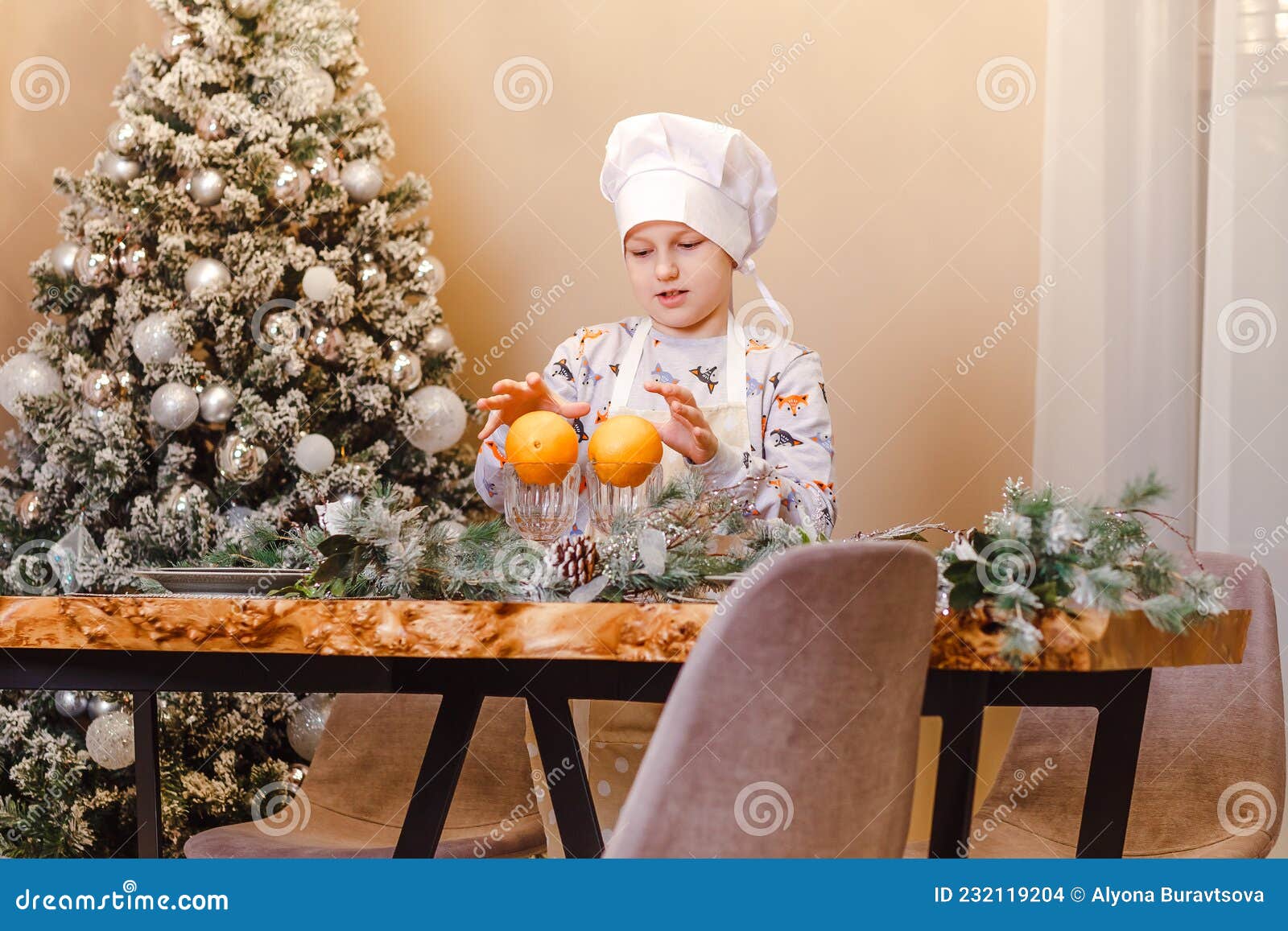 Tenyearold Boy in Cap and Apron Cooking Christmas Dinner Stock Photo