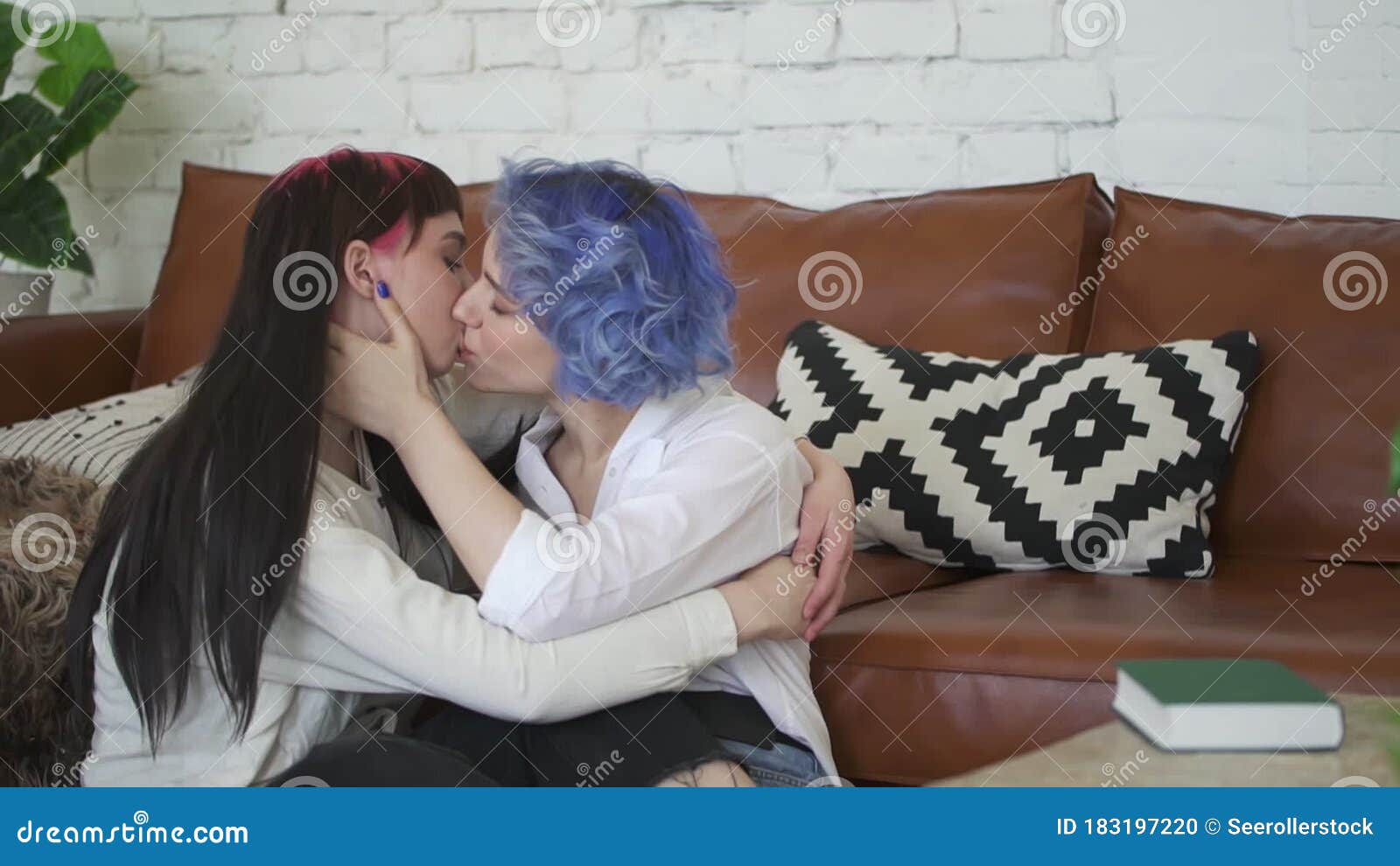 Tender Kiss between Young Lesbian Couple at Home picture