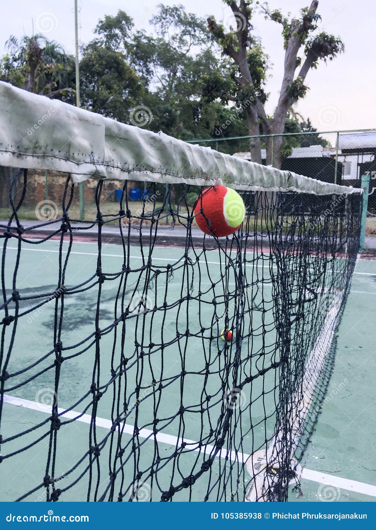 Tennis ball in the net stock photo. Image of outdoor 105385938