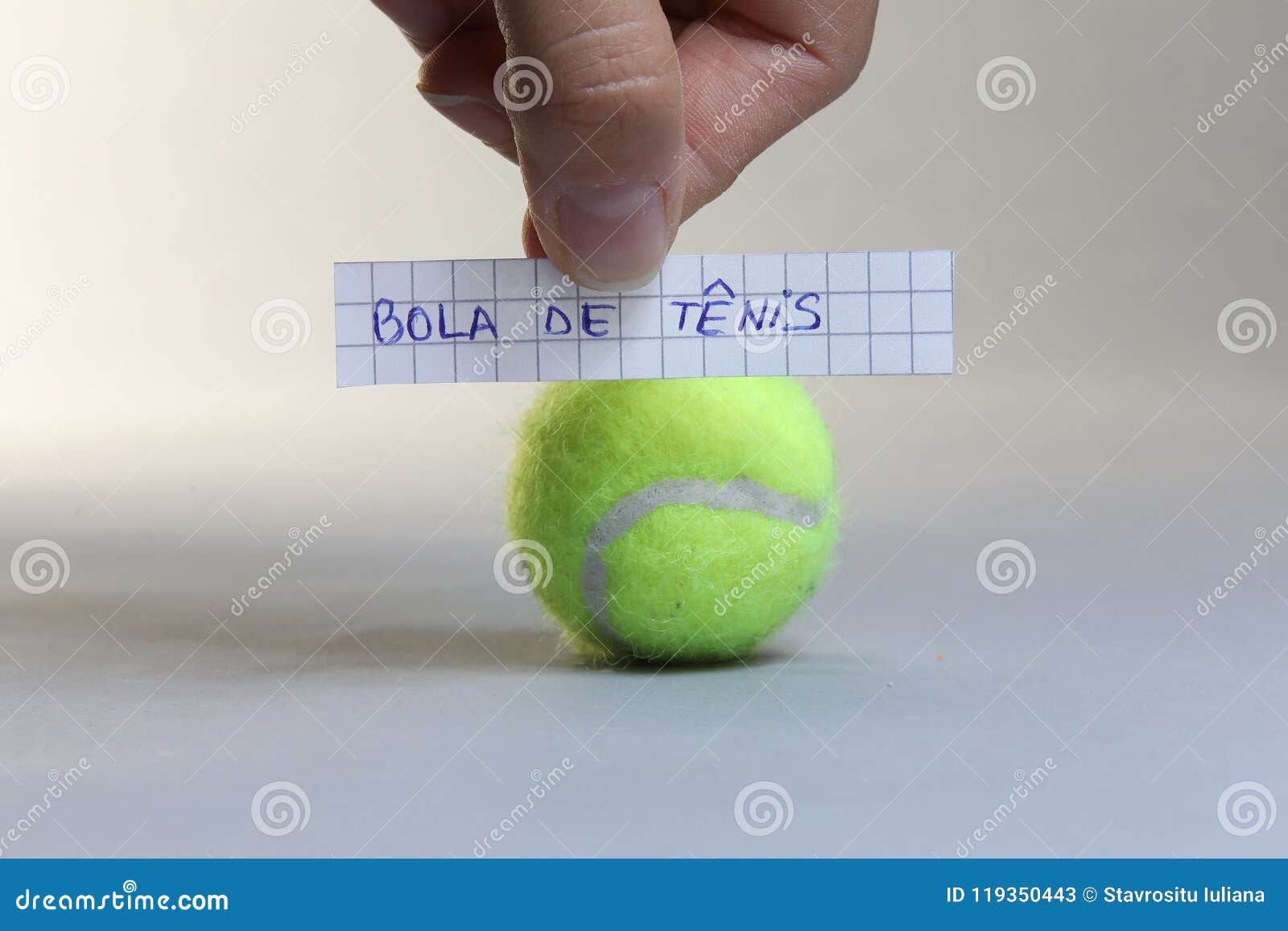 tennis ball word written on a piece of paper, bola de tenis in spanish language