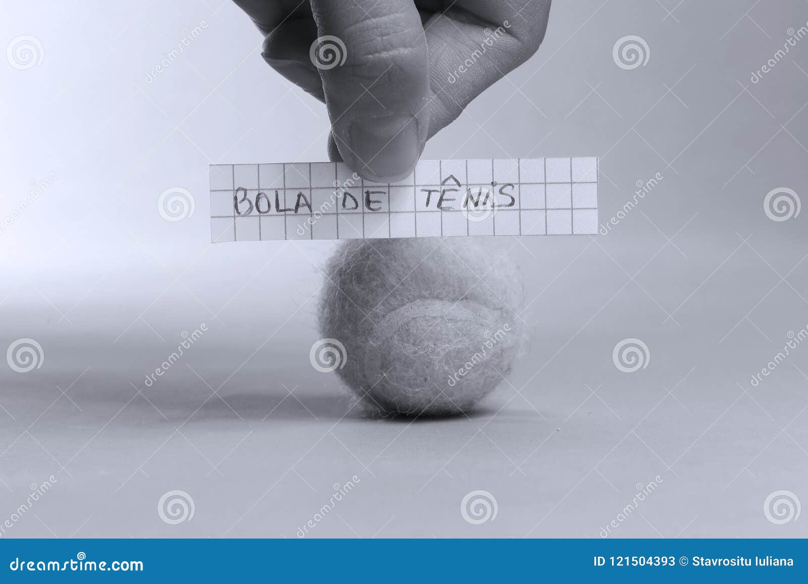 tennis ball word written on a piece of paper, bola de tenis in spanish language