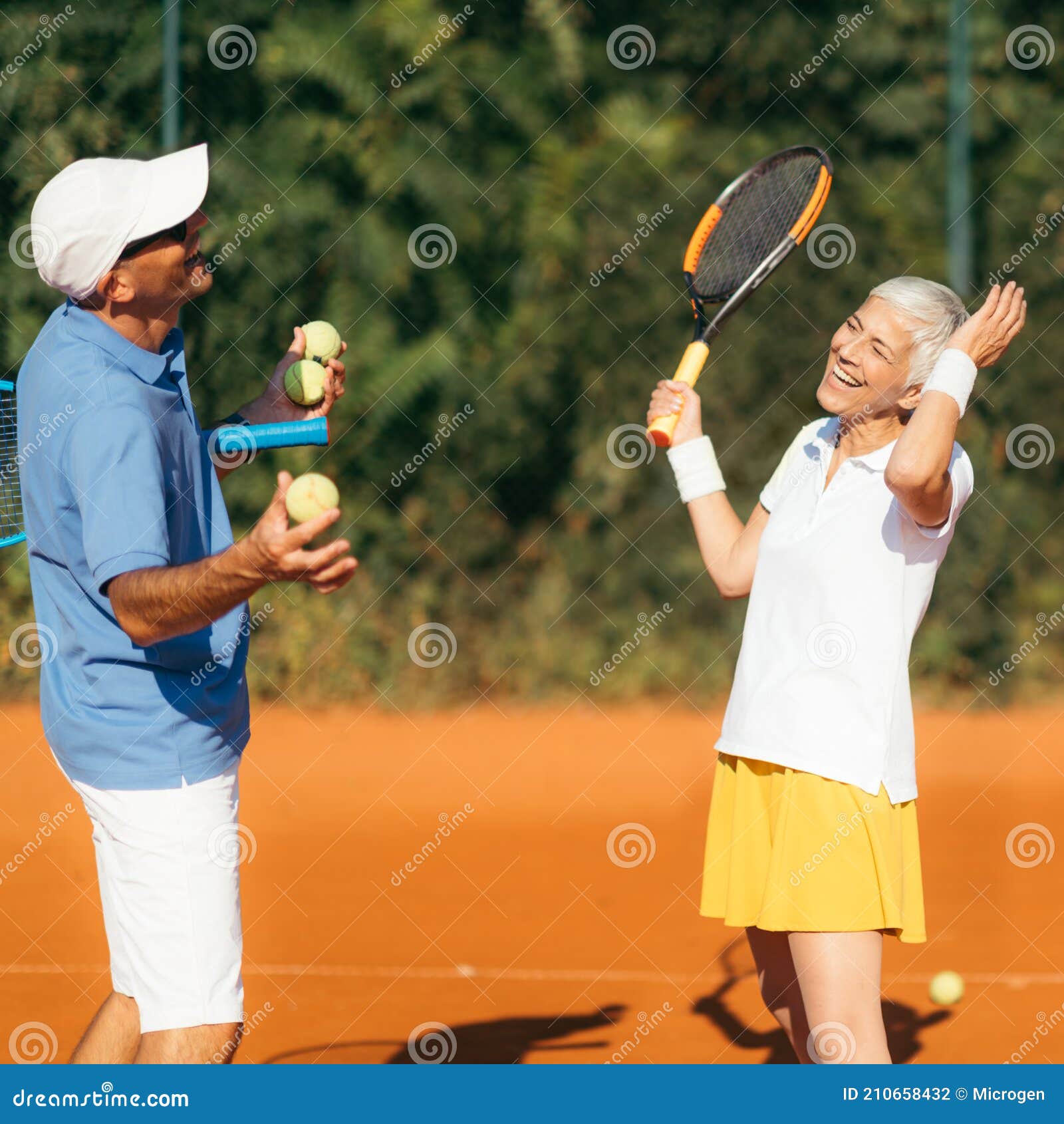 Tennis Instructor with Senior Woman, Tennis Training Lesson Stock Photo