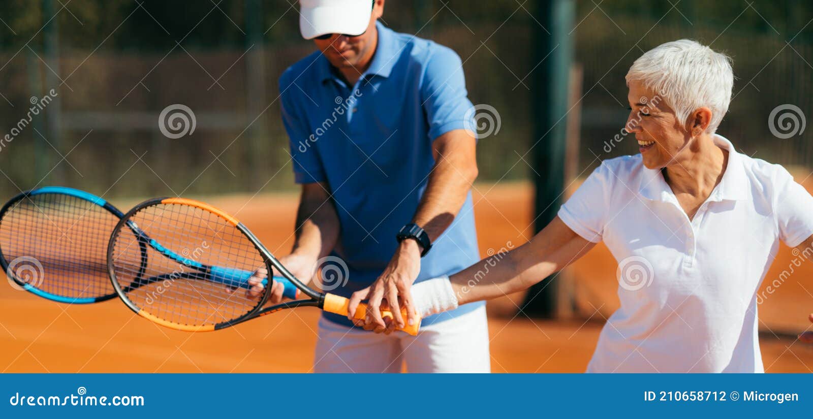 Tennis Instructor with Senior Woman, Tennis Training Lesson Stock Photo