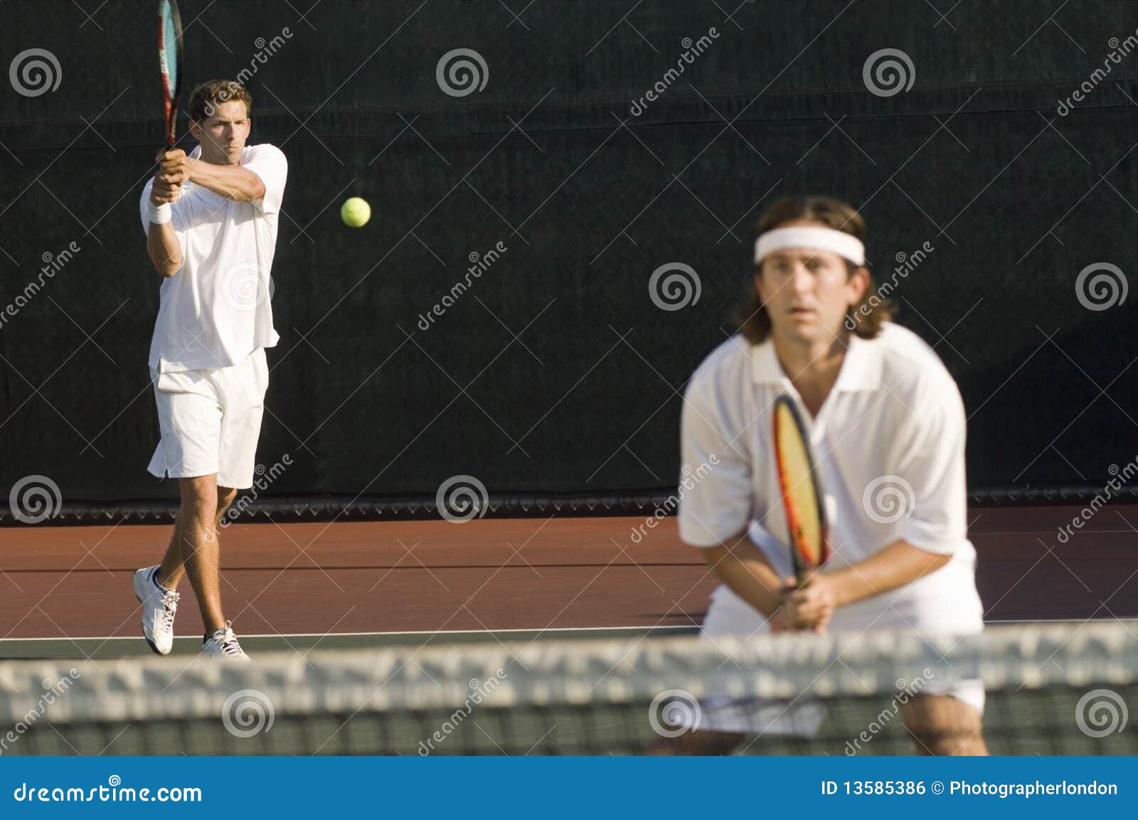 tennis player hitting backhand