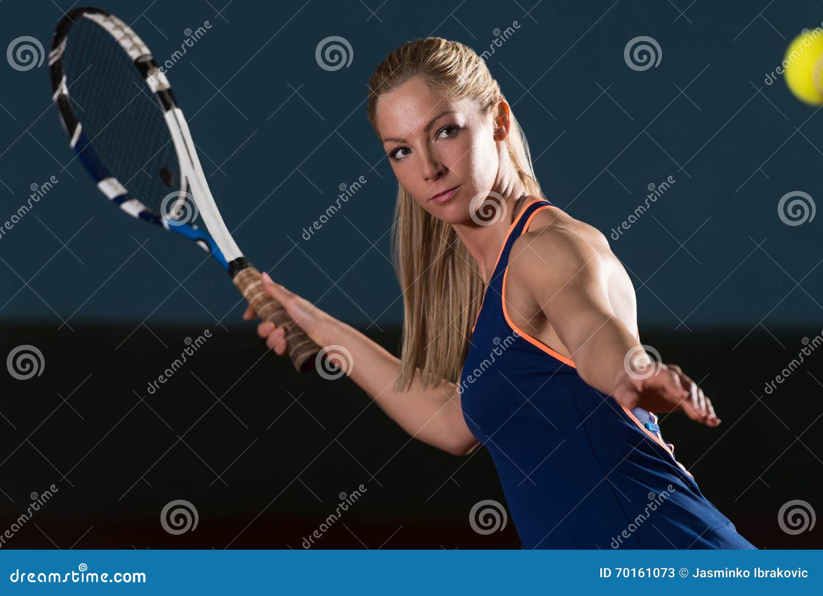 tennis player hitting tennis ball