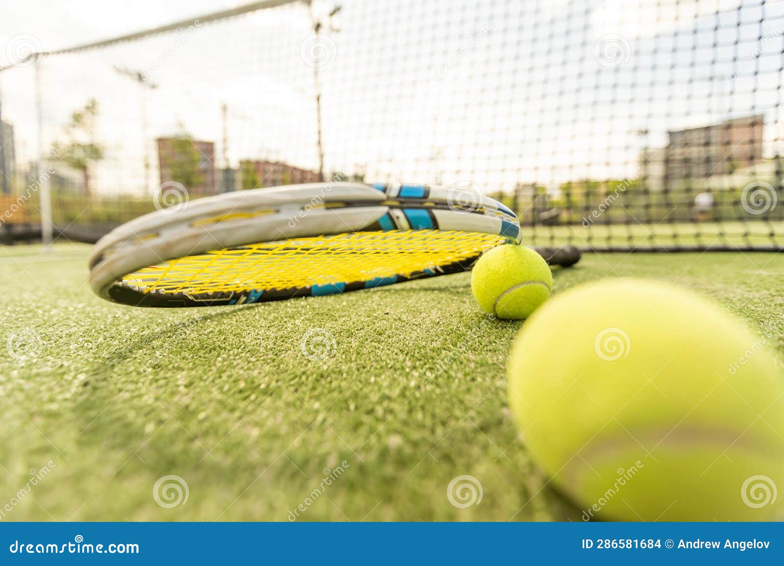 Tennis Racket with a Tennis Ball on a Tennis Court Stock Photo Image