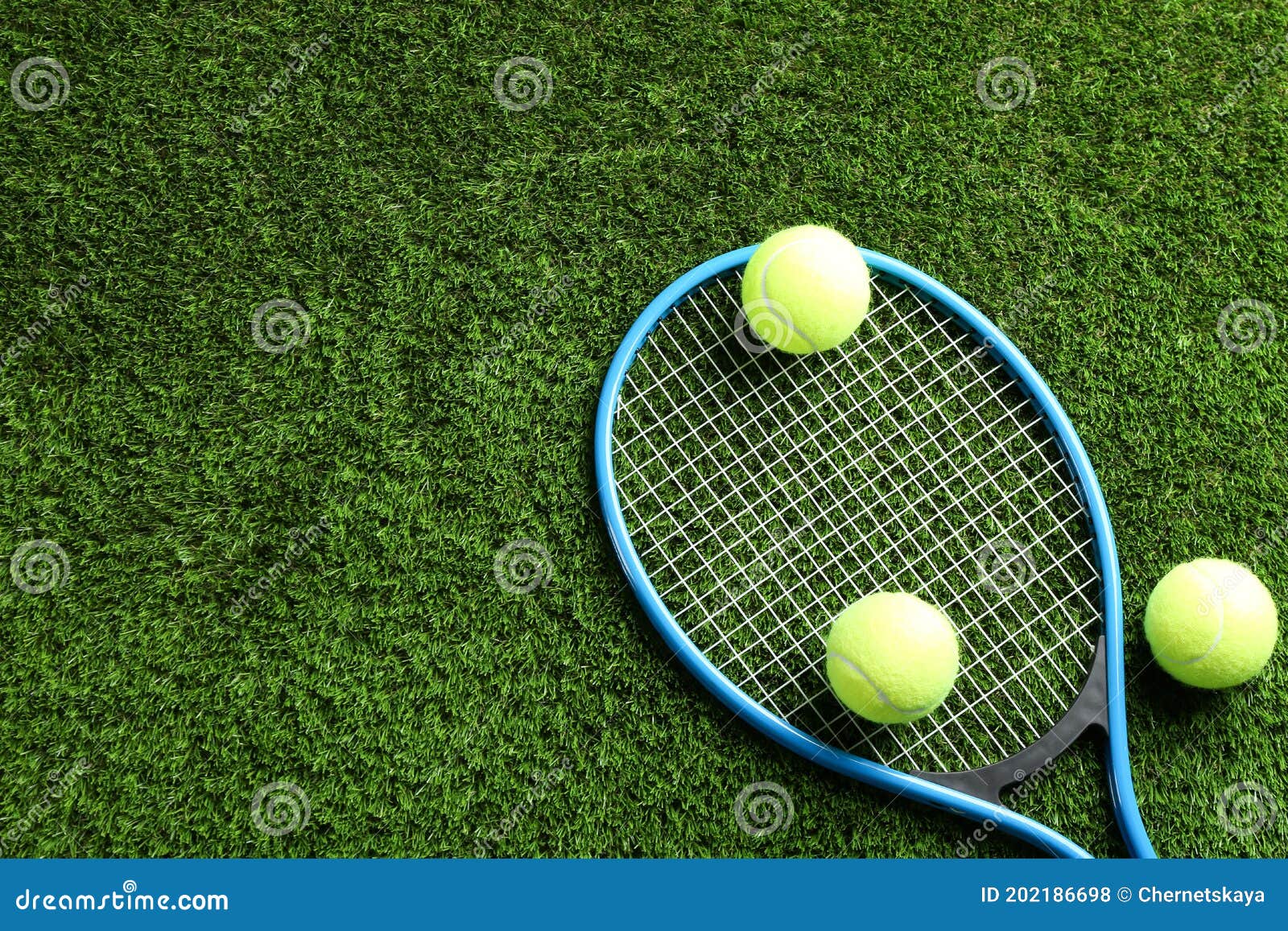 Tennis Racket and Balls on Green Grass, Flat Lay. Space for Text Stock