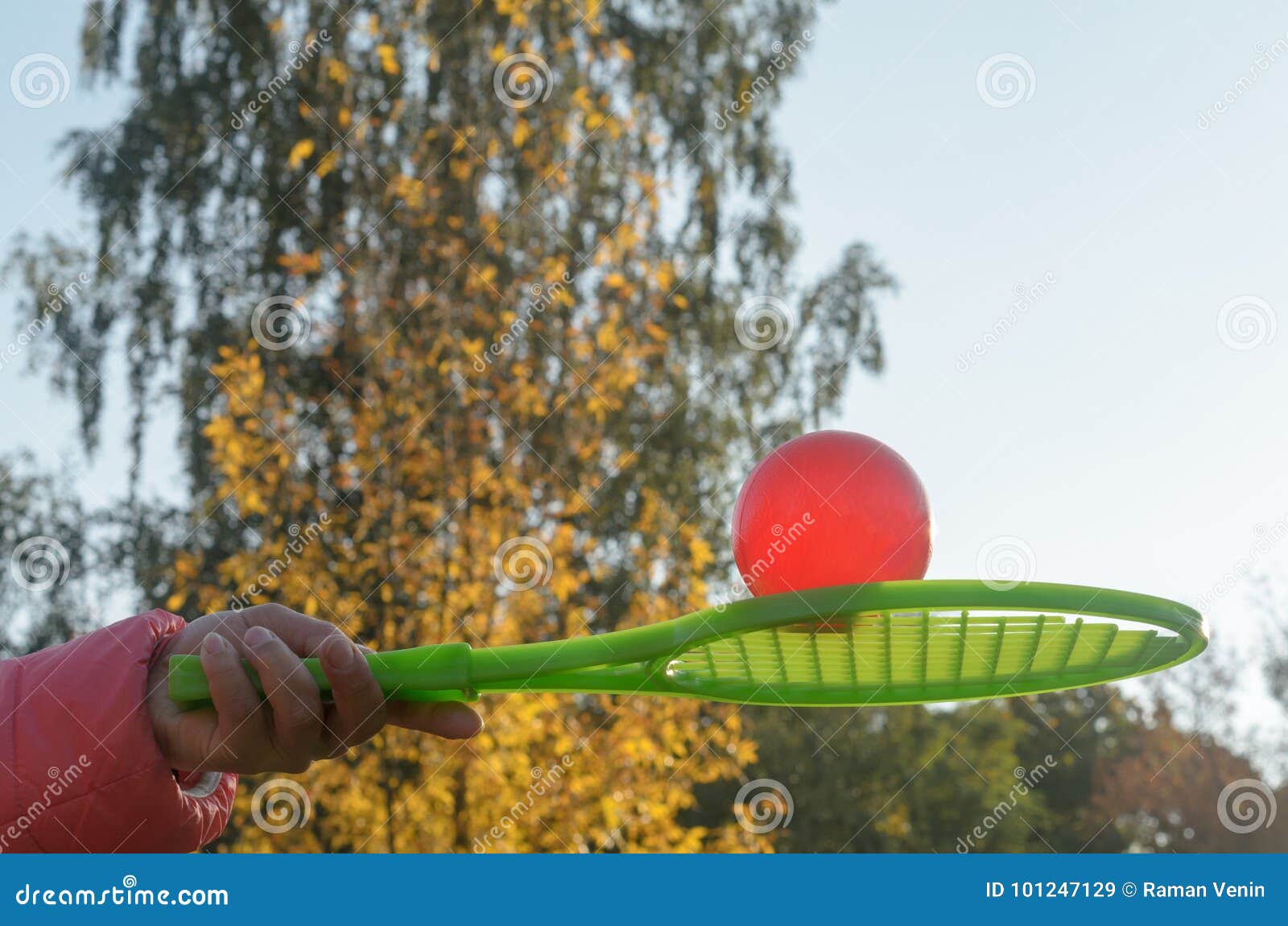A Tennis Racket in His Hand Catches the Ball in Motion. Stock Image