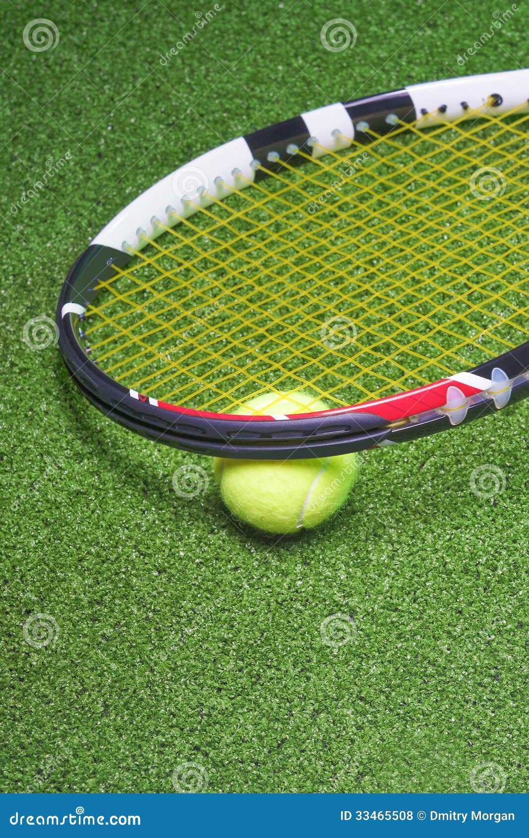 Tennis Racquet with Ball Over Green Artificial Grass Stock Photo