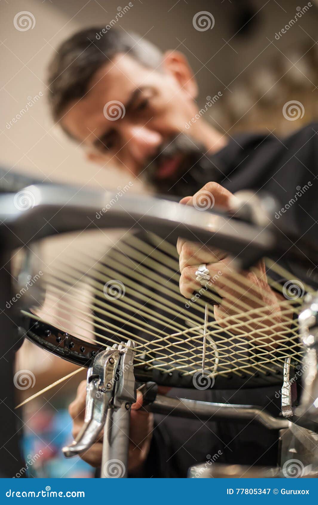 Tennis Stringer Holding Awl and Doing Racket Stringing Stock Image
