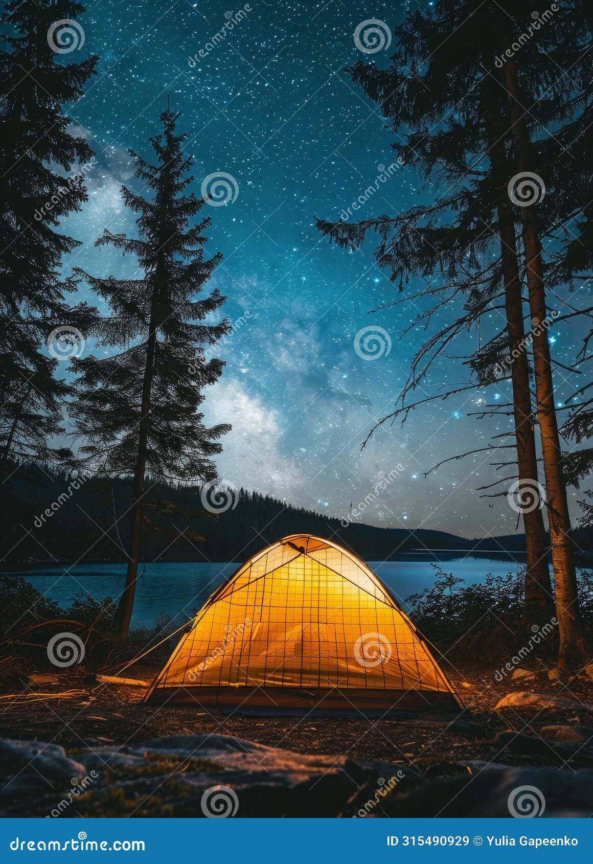 tent pitched on lake shore under night sky