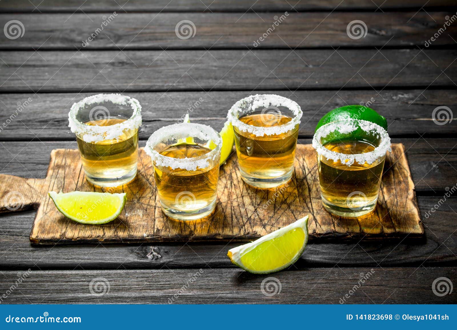 Tequila in a Shot Glass on a Cutting Board with Slices of Lime Stock ...