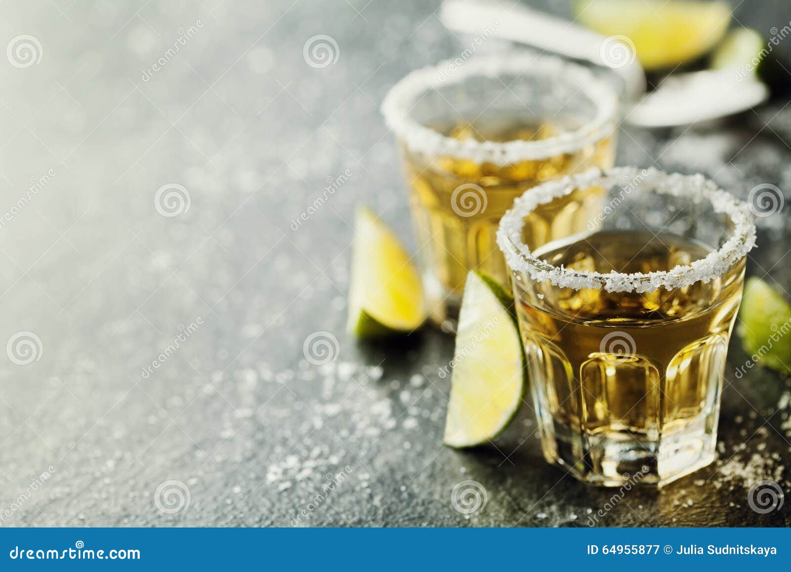 tequila shot with lime and sea salt on black table